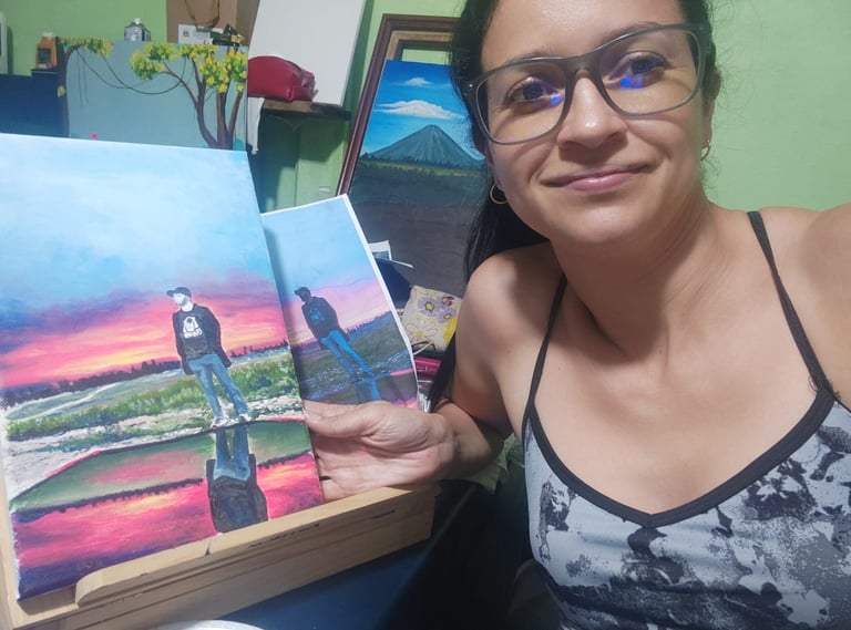 Woman wearing glasses smiling while holding printed photos of a sunset landscape at home