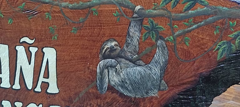 Mural featuring a gray llama or alpaca illustration with green foliage on a rust-red background with partial white text