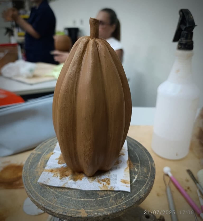 Wooden egg-shaped sculpture with vertical grooves on a circular base in a workshop setting